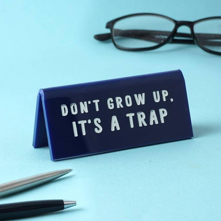 'Don't Grow Up, It's A Trap' Blue Desk Sign